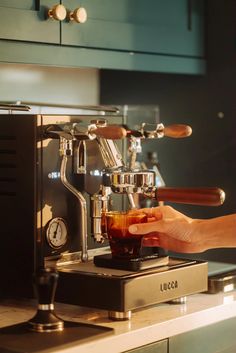 the espresso machine is being filled with liquid and ready to be used by someone