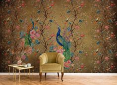 a peacock sitting on top of a chair in front of a flower covered wallpaper