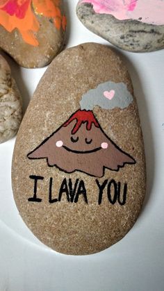 some rocks that have been painted with children's drawings on them and the words i lava you