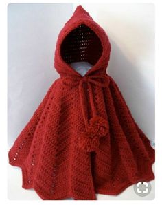 a crocheted red cape with a hood