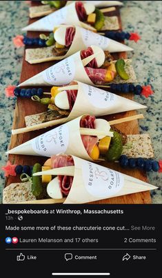 a wooden board topped with lots of different types of food on top of each other