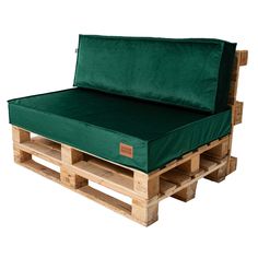 a bed made out of wooden pallets with a green mattress on top of it