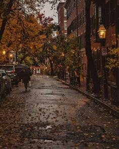 a person walking down a street with an umbrella