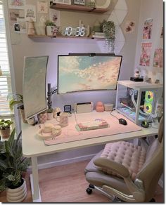 a desk with a computer on it in a room filled with plants and other items