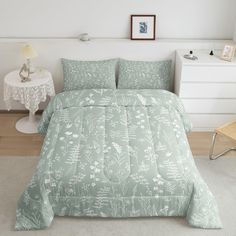 a bed in a bedroom with a green comforter