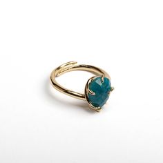 Apatite Adjustable Ring Apatite, known as the "Stone of Manifestation," is cherished for its vibrant blue and green hues and its ability to enhance personal power and creativity. Historically, this gemstone has been used to inspire positive change and unlock potential. The Apatite Adjustable Ring, crafted from non-tarnished metal, combines the energetic qualities of apatite with a modern, versatile design. Product Details Gemstone: Apatite - Recognized for its striking blue and green colors, sym Apatite Ring, Blue Gemstone Ring, Healing Crystal Ring, Green Hues, Personal Power, Ring Blue, Crystal Ring, Vibrant Blue, Positive Change