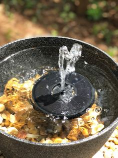 a black bowl with water running out of it