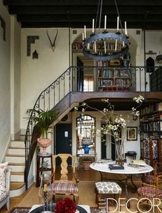 a living room filled with furniture and a spiral staircase