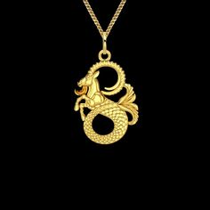 a gold dragon pendant on a black background