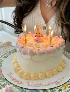 a birthday cake with lit candles on it