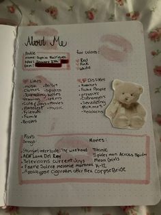 an open notebook with writing on it and a teddy bear sticker attached to the page