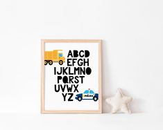 a white wall with a black and yellow alphabet print on it next to a star