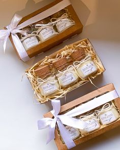 two small boxes filled with soaps sitting on top of a table