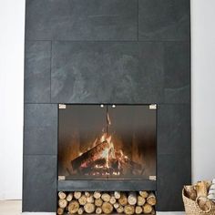 a fireplace with logs in front of it