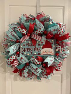 a christmas wreath hanging on the front door with santa's helper and other decorations