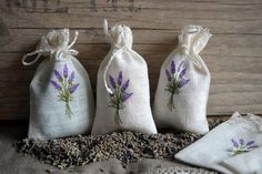 three bags filled with lavender flowers sitting on top of a table