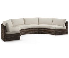 an outdoor sectional sofa with cushions and pillows on the back, in front of a white background