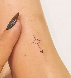 a woman's arm with a small star tattoo on the left side of her leg