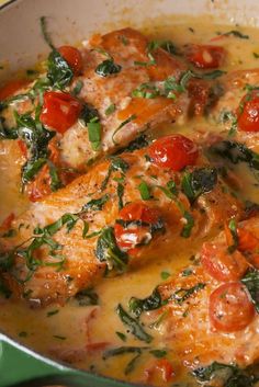 chicken with tomatoes and spinach in a skillet