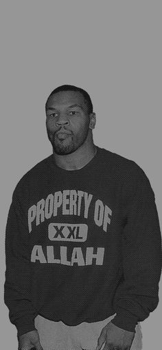 a black and white photo of a man wearing a sweatshirt that says property of allah