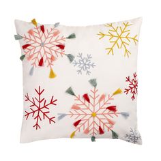 a white pillow with colorful snowflakes on it