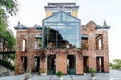 an old brick building with a glass front door and large windows on the top floor