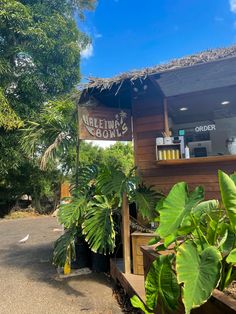 an outside view of a restaurant with plants and trees