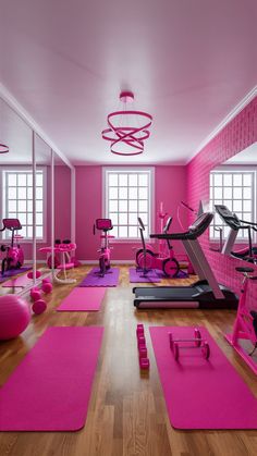 a pink gym room with exercise mats on the floor