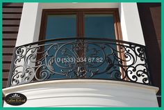 a balcony with wrought iron railing and windows