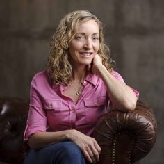 a woman sitting on top of a brown chair