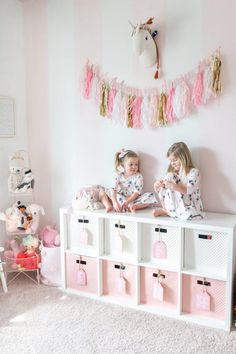 Sharing a full tour of our pink and white striped girls playroom with gold accents on the blog! We've lived in this playroom for almost 4 years now, and have updated quite a bit. We've added a few more storage and organizational pieces to make the room function well for us! #playroom #playroomdecor #pinkandwhitestripes #tassels #childrensdecor #kidsdecor #girlsroomdecor #unicorndecor #pinkandgold #goldaccents #homedecor Pink Dinosaur Room Decor, Pink Playroom, Small Playroom, Kids Bedroom Storage, Shared Girls Room, Girls Playroom, Toddler Girl Room, Playroom Design, Toddler Rooms