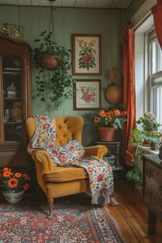 a living room filled with lots of furniture and flowers on the wall next to a window