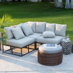 a couch and ottoman on a patio with grass in the background