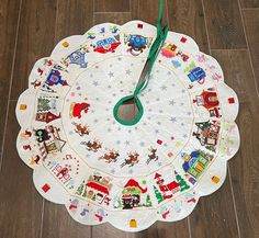 a christmas themed placemat on the floor with a clock hanging from it's center