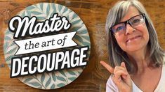 a woman pointing to the side of a sign that says master, the art of decoupage