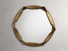 a round mirror hanging on the wall