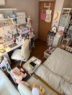 a room filled with lots of toys and furniture next to a wall covered in shelves