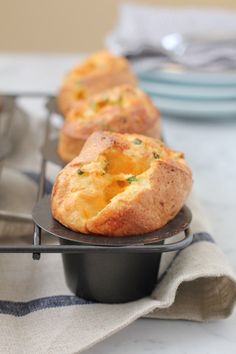 several muffins sitting in black trays on a table