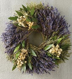 a lavender wreath hanging on the wall