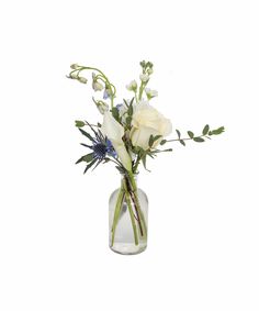 a vase filled with white flowers and greenery