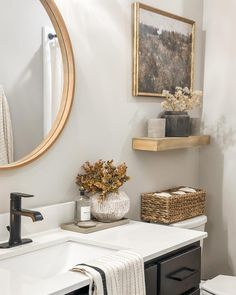 a bathroom with a sink, toilet and mirror