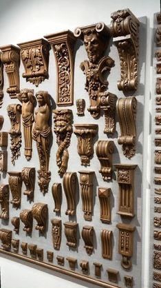 an assortment of carved wooden corbs are displayed on the wall in a museum