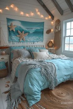 a bedroom decorated in blue and white with starfishs on the wall above the bed