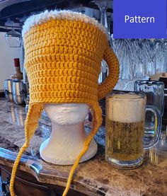 a crocheted yellow hat sitting on top of a white mannequin head