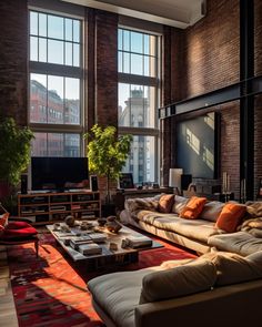 a living room filled with lots of furniture next to large windows on top of a brick wall