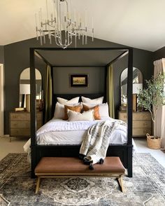 a bedroom with a canopy bed and chandelier