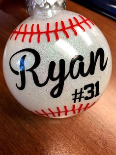 a baseball ornament with the name ryan on it