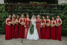 a group of women in red dresses standing next to each other