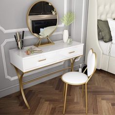 a white desk with a gold frame and mirror on it, next to a bed