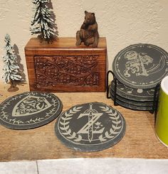 a table topped with coasters next to a wooden box